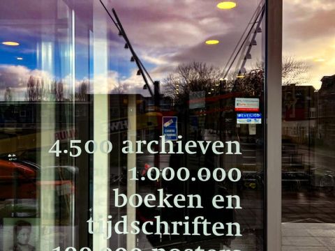 Text On The Door To The IISH, means 4,500 Archives, 1 Million Books and Magazines, 100 thousand posters in Dutch  Photo Credit: Cherelle Karsseboom