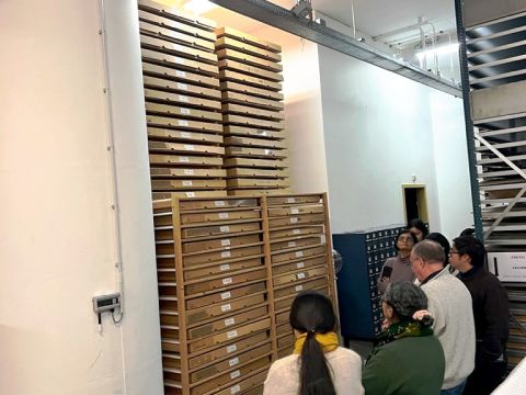 Eef and the IIAS fellows looking at the IISH's collection of textiles. Each box contains material picked up and donated from protests and social movements around the world  Photo Credit: Cherelle Jaleesa Karsseboom
