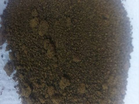 Dark brown Soumbala powder laid out on a paper towel; Credit: Jocelyne Vokouma, 2024